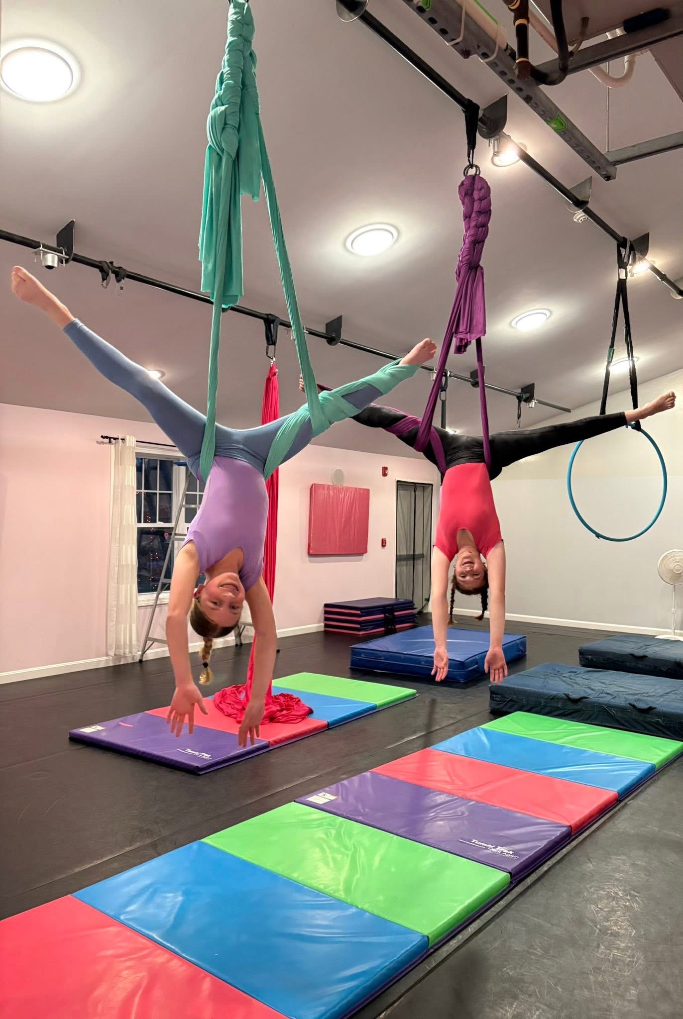 Two L.A. Dance students practicing aerial silks together in the studio