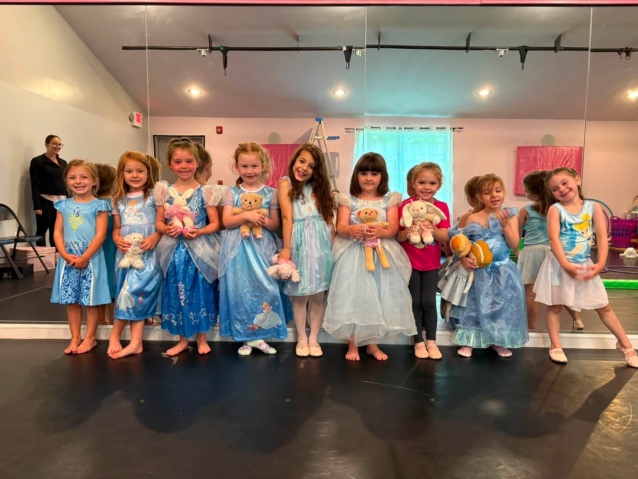 A group of young L.A. Dance students smiling together in the studio